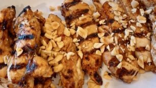 Grilled chicken with satay sauce and crushed peanuts on top