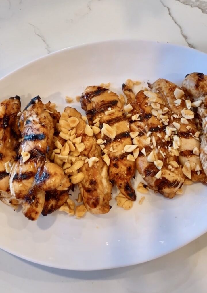Grilled chicken with satay sauce and crushed peanuts on top