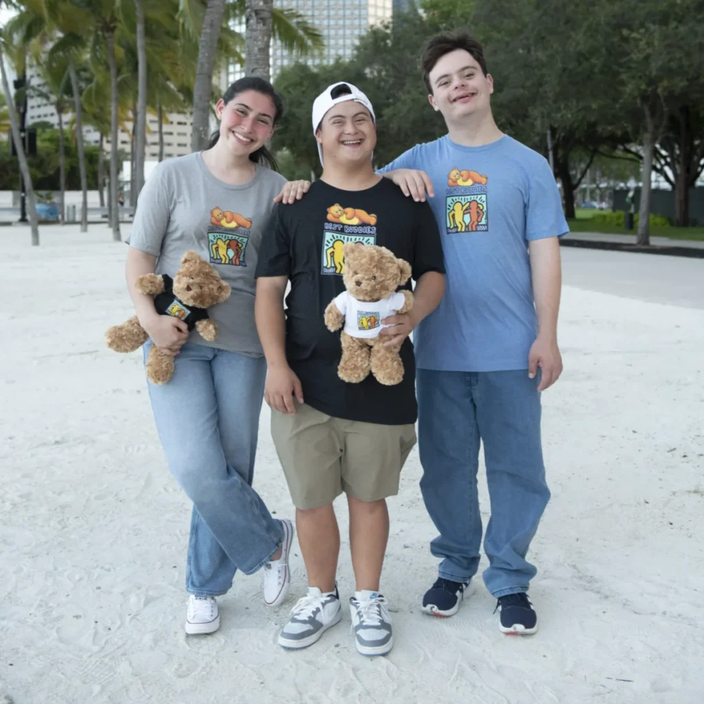 Three people wearing the Teddie Peanut Butter and Best Buddies limited-edition t-shirt