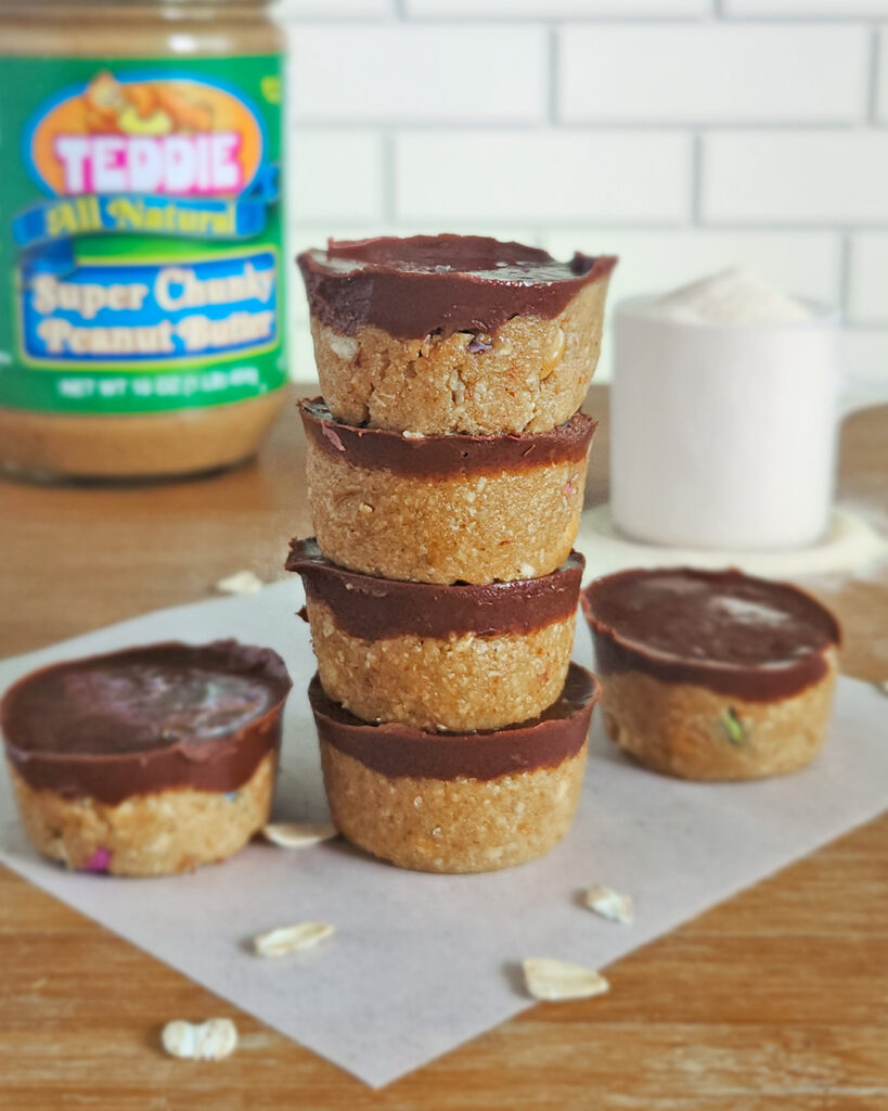 Four bite-size peanut butter protein oat cups stacked on top of each other
