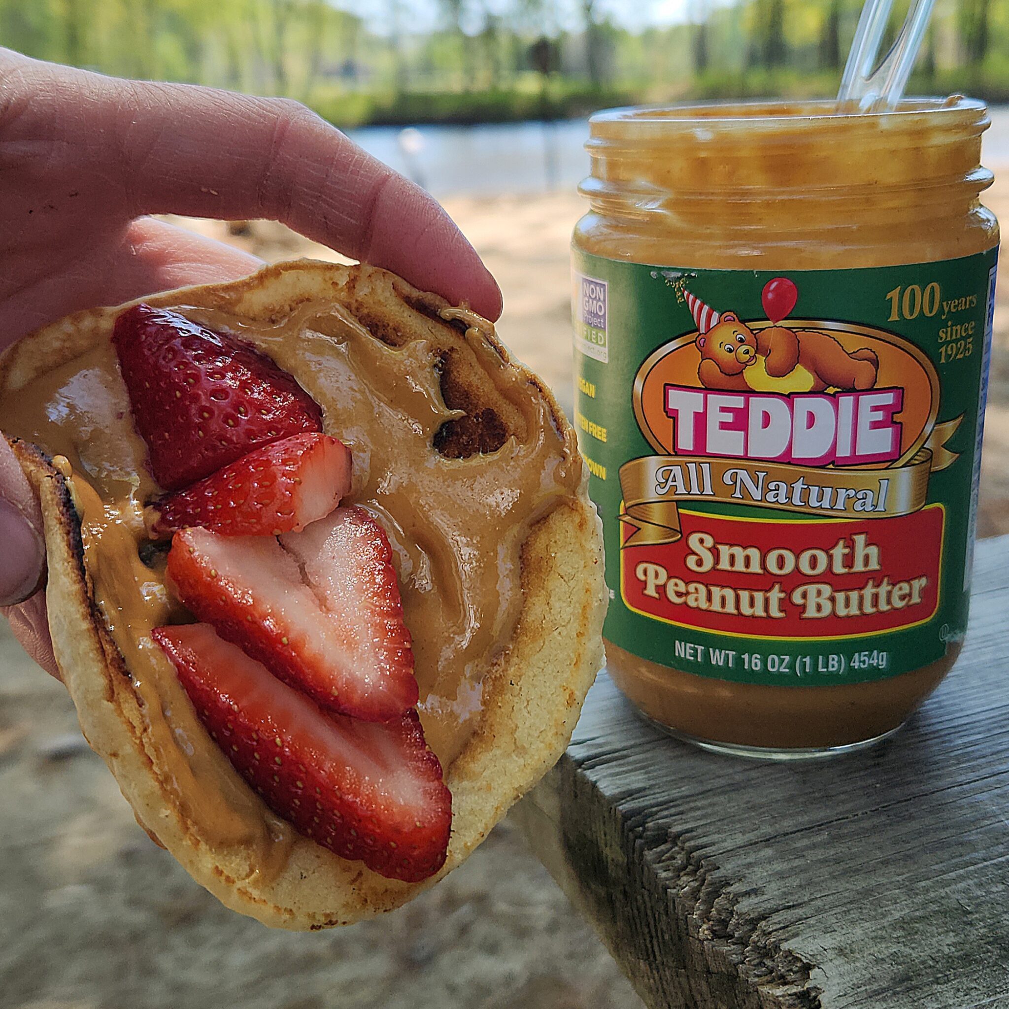 Teddie Peanut Butter on a pancake topped with fresh strawberries