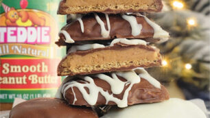 Buckeye graham crackers on a plate surrounding by holiday decorations.